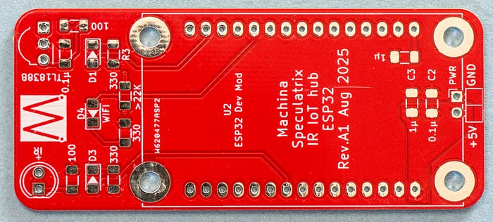 Close-up photograph of a red PCB with no components attached with the words: Machina Speculatrix IR IoT hub ESP32 Rev.A1 Aug 2025.