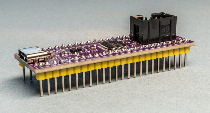 Close-up photograph of a printed circuit board with header pins.