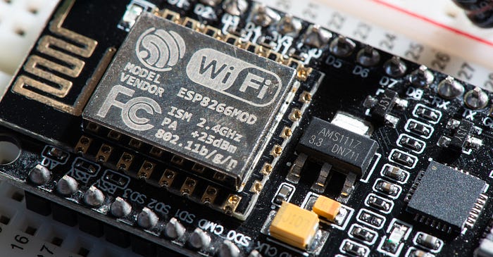 Close-up photograph of an electronic development board. The words ‘WiFi’ and ESP8266MOD are visible.