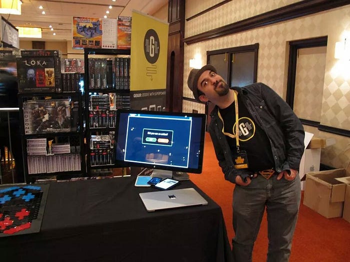 Yours truly posing next to the app I built, at a trade show.