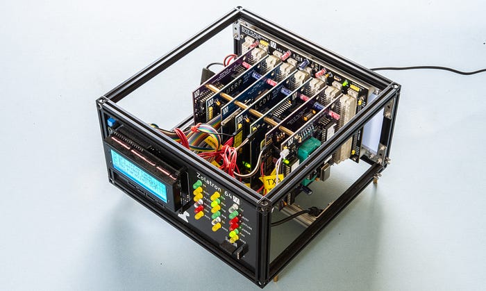 Top view of a homemade computer built into a metal frame showing multiple circuit boards plugged into a backplane.