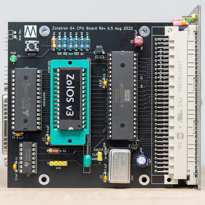Photograph of an eletronics circuit board incorporating four chips. One of the chips, with the marking ‘ZolOS v3’, is in a zero insertion force socket.